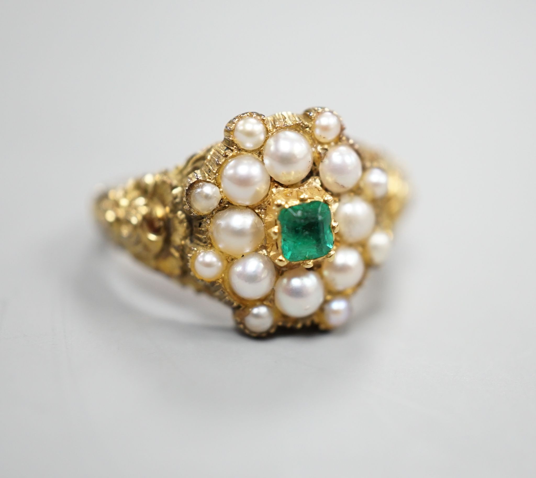 A Victorian style yellow metal, emerald and split pearl cluster set dress ring, size M, gross weight 3.6 grams.